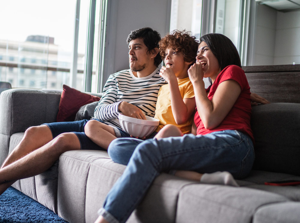 family watching tv on couch