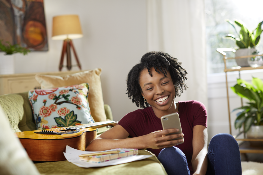 A mom reading a testimonial on her phone.