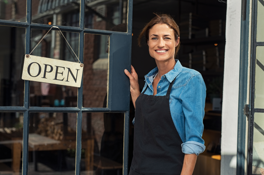 A smiling small business owner looking.