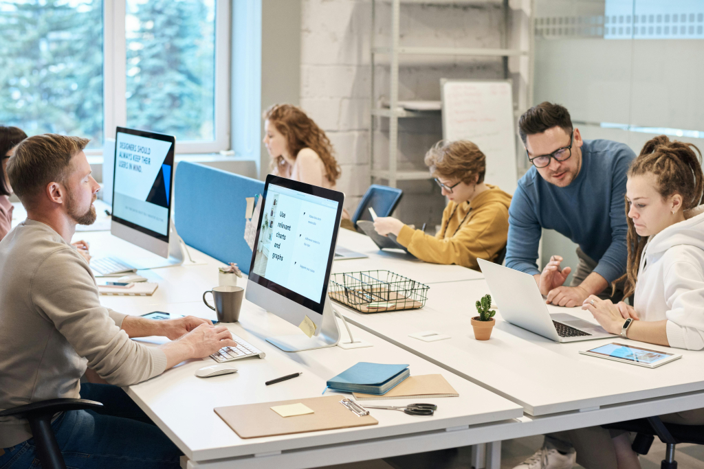 A modern tech startup team collaborating in a well-lit office, with sleek devices and a dynamic atmosphere.