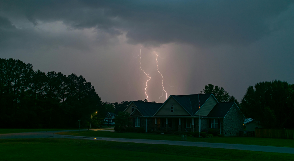 Lightning striking near a cozy home, symbolizing protection and security.
